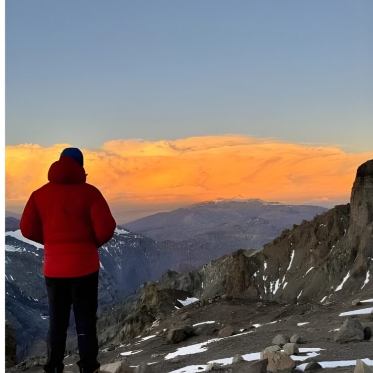 Exhausted mountaineer showing mental determination during high altitude summit push on Aconcagua