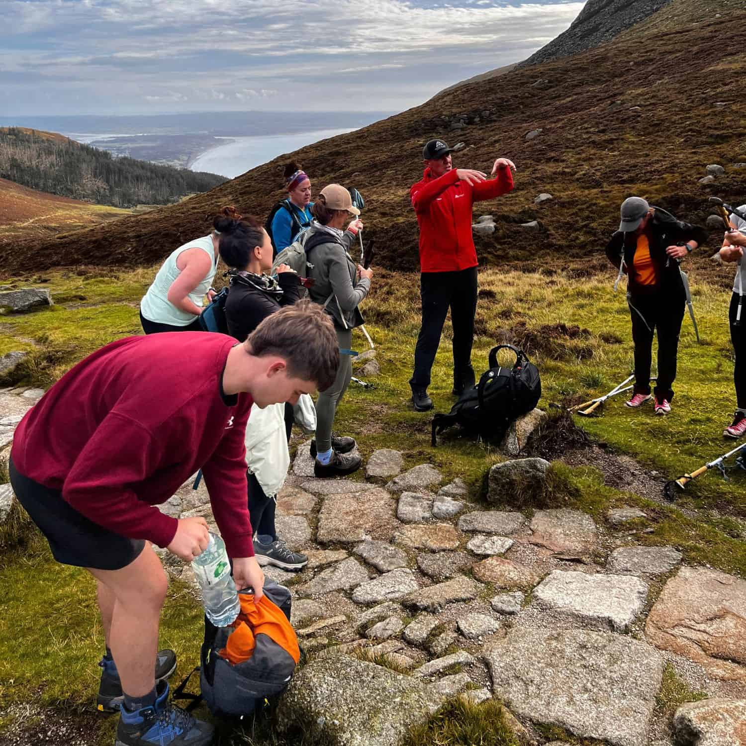 Corporate sustainability team practicing Leave No Trace principles during Irish mountain challenge