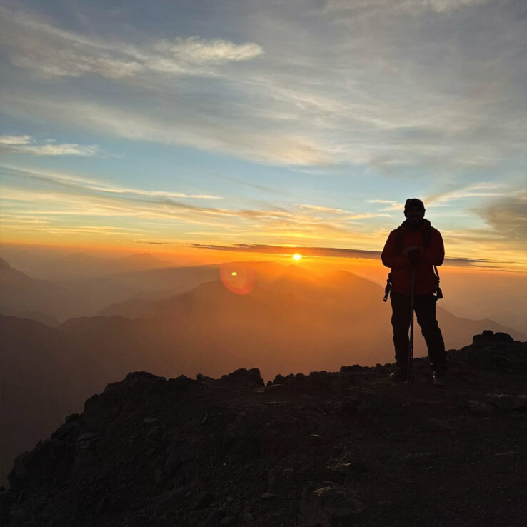 Mountain guide leading ethical Leave No Trace training at dawn on Irish peak