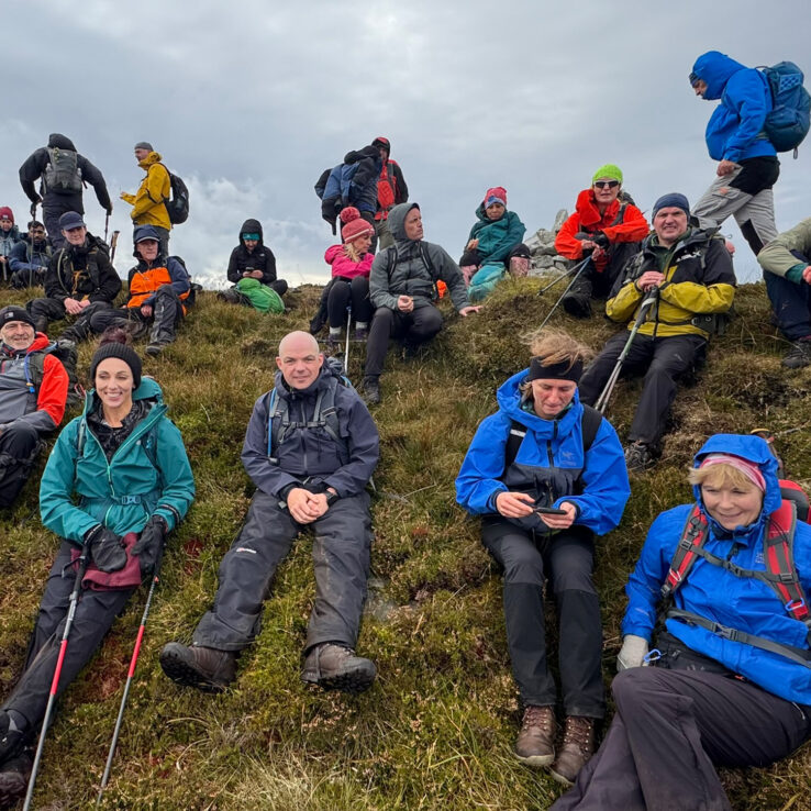 Exhausted team members resting on luxury expedition bus between mountain climbs