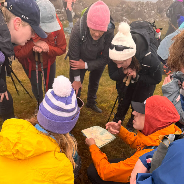 Corporate team training together with hill repeats in preparation for mountain challenge