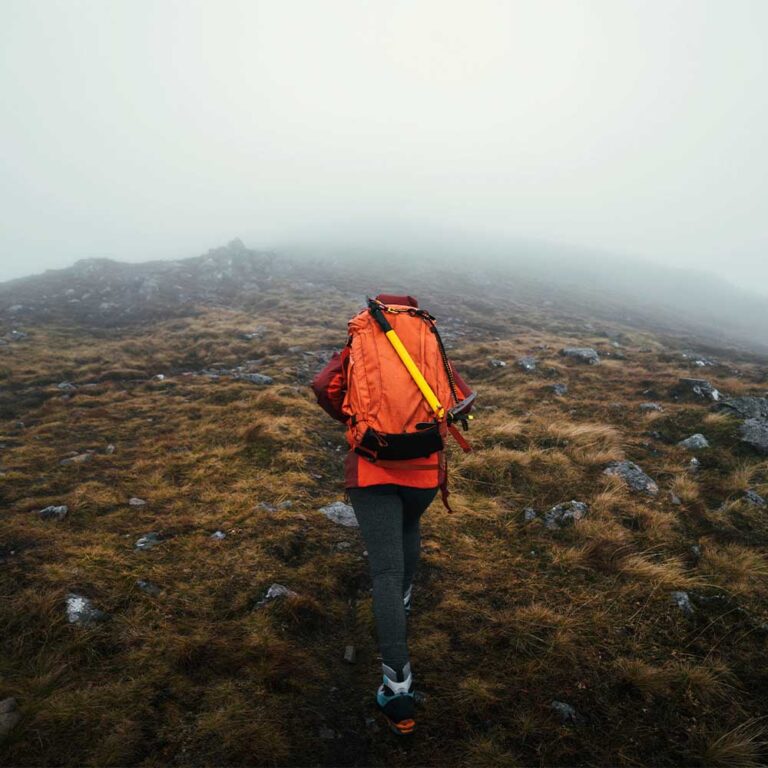 Hiker carefully navigating rocky descent on Carrauntoohil Ireland's highest peak