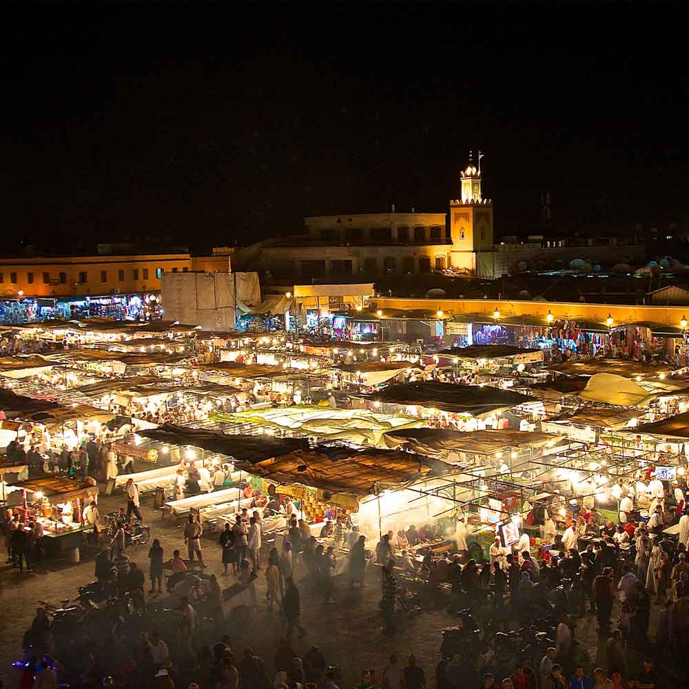 Bustling Jemaa el-Fna square in Marrakesh Medina contrasting mountain silence