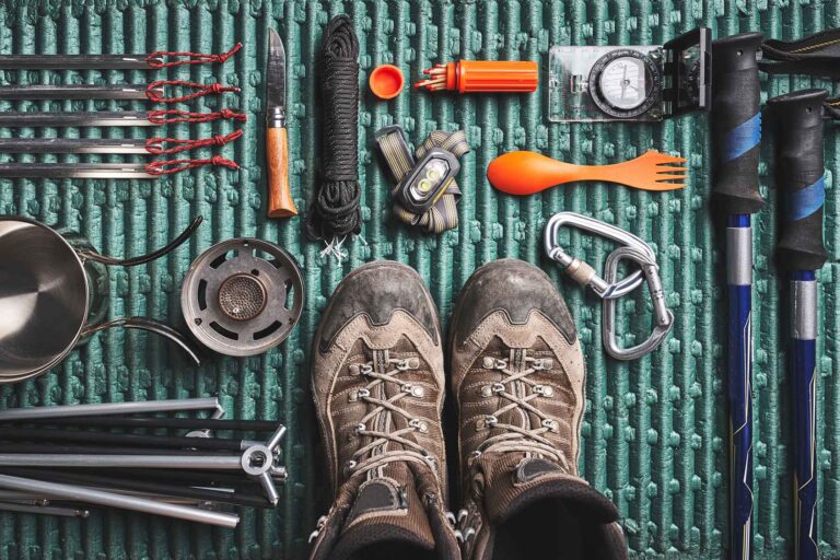 Wet hiking boots, map, and gear from Wales 7 Summits Challenge showing mental resilience required
