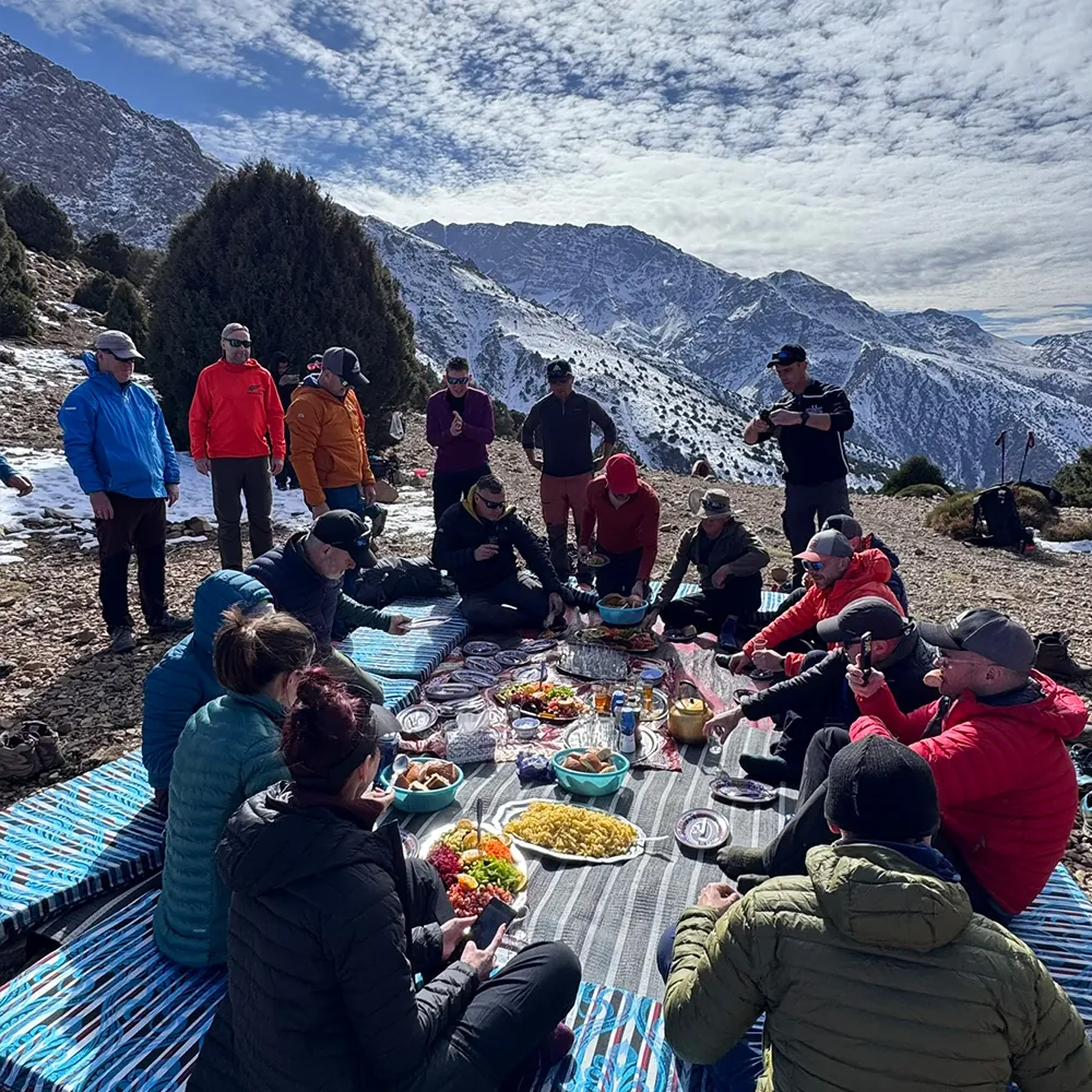 Expedition cook team preparing meals at High Atlas base camp Morocco 7 Summits