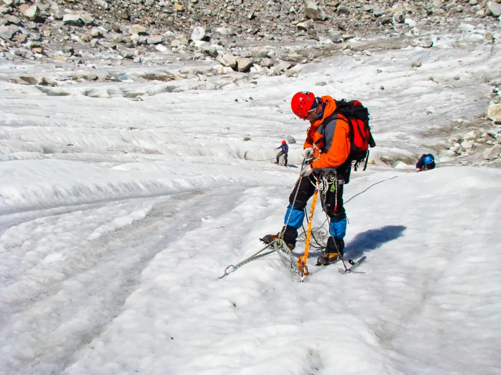 Mountaineer on glacier with crampons and ice axe at high altitude Nepal Himalayan expedition