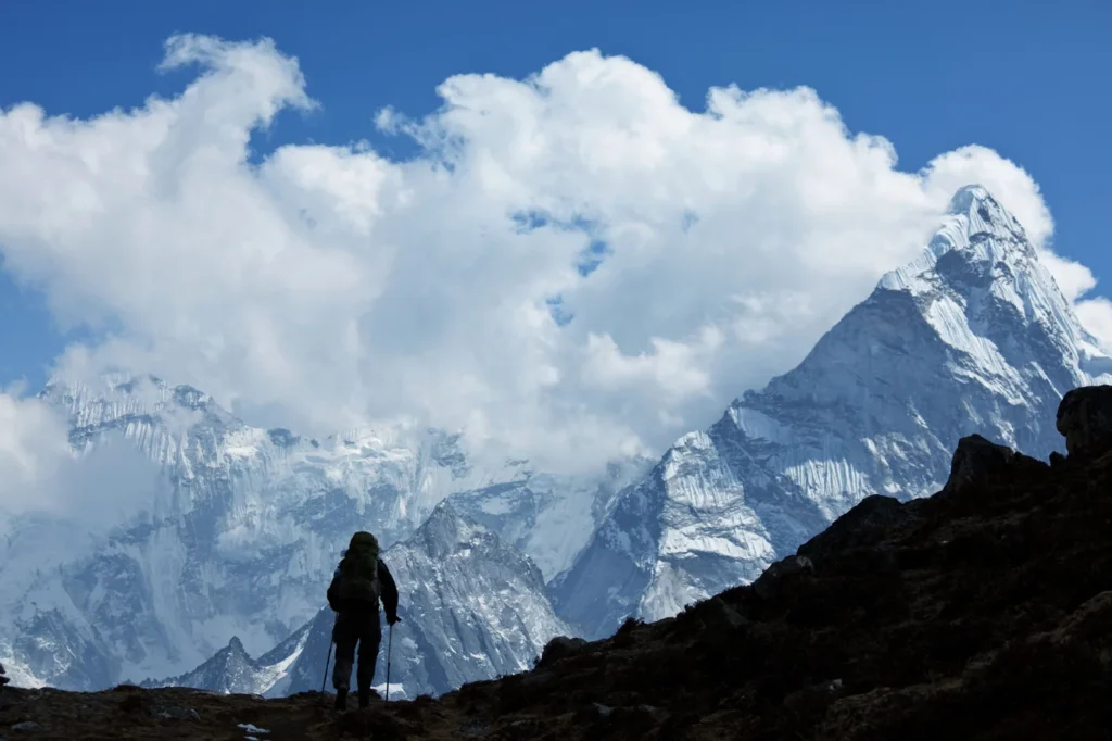 Climbers ascending fixed ropes on glacier terrain on Himlung Himal Southwest Ridge at high altitude Nepal