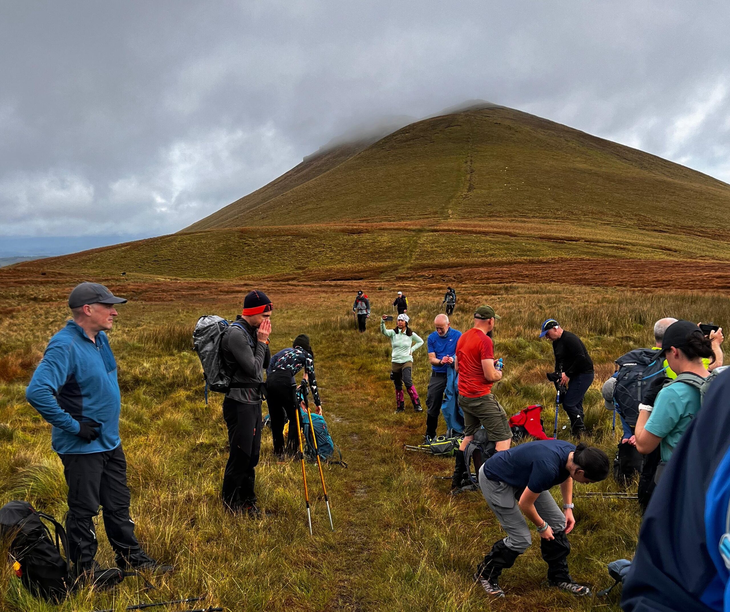 Careful gear preparation before setting out on a technical mountain challenge. Mountaineers checking technical gear before a national summit challenge departure