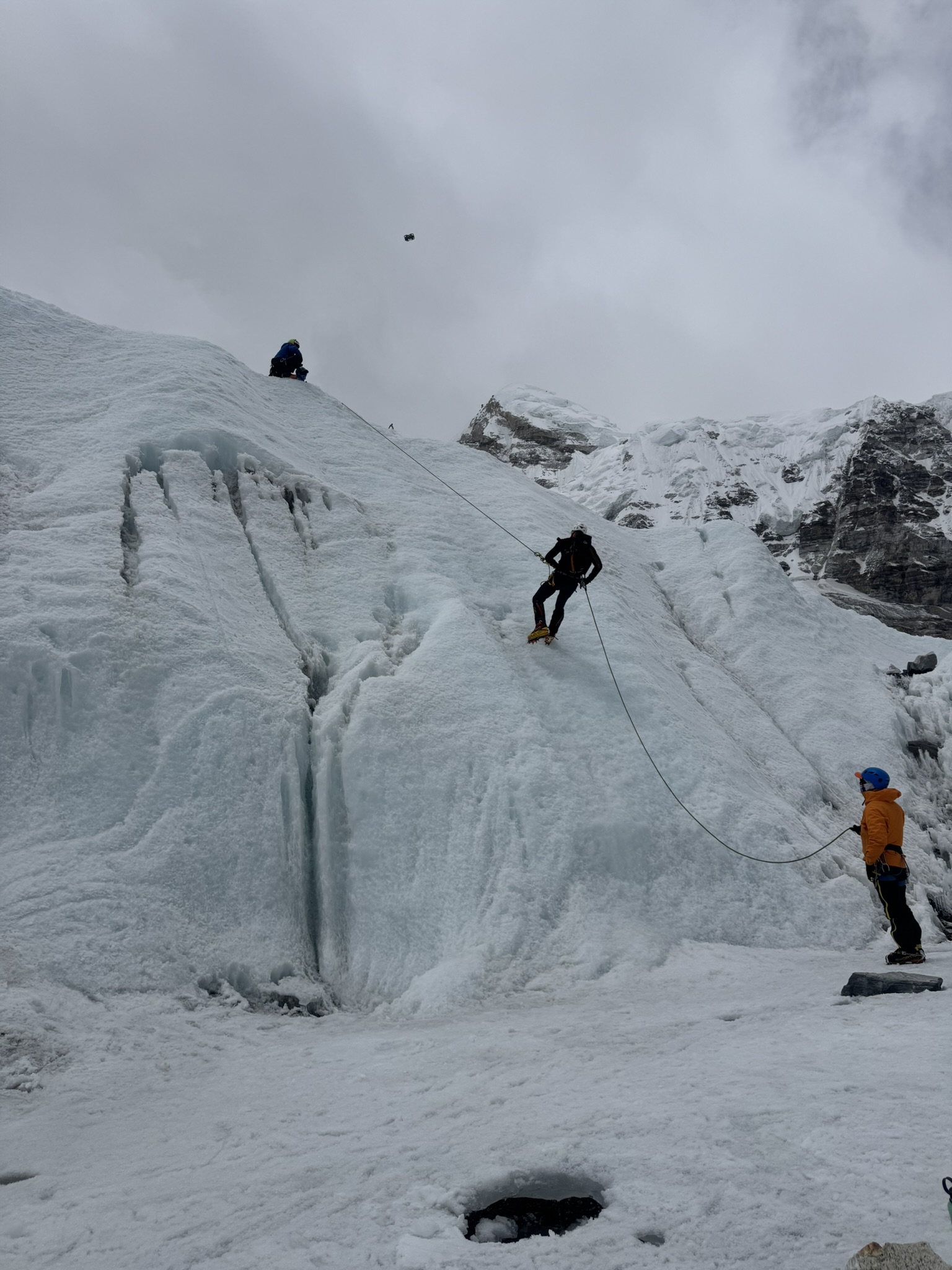 Winter mountaineering team practicing companion rescue in snow.