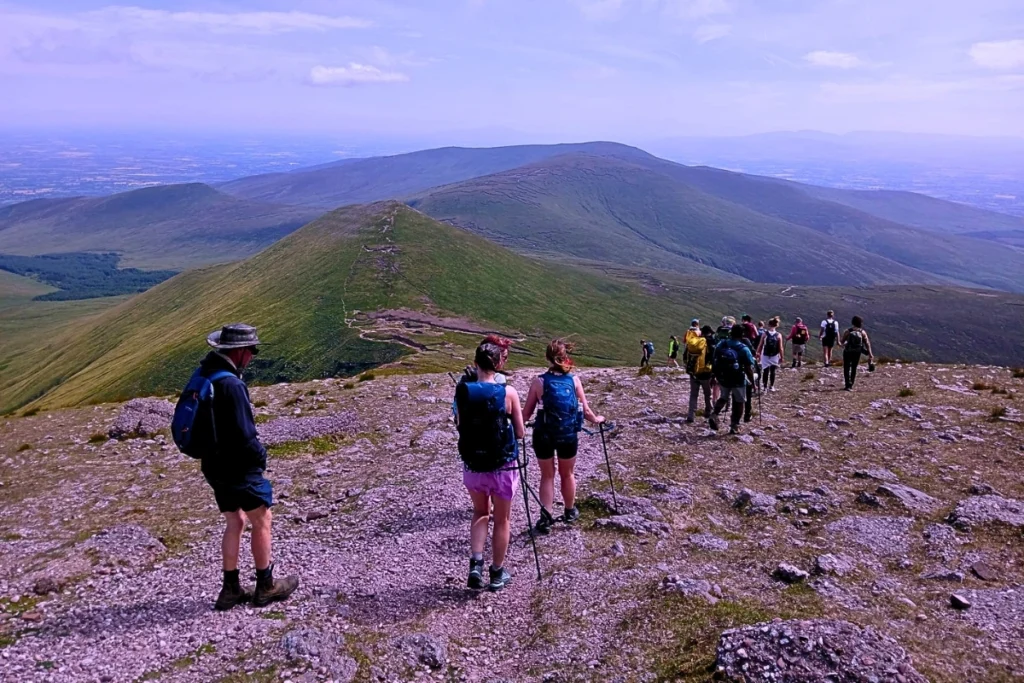 Hikers traversing the Glencoaghan Horseshoe in the Twelve Bens, Connemara